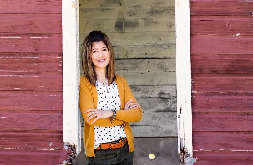 Laura Sandretti - Christian Speaker, Author & Blogger standing in barn window